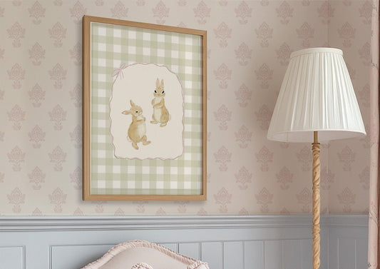 Pink armchair with a white pillow, framed artwork, and standing lamp in a room with patterned wallpaper.