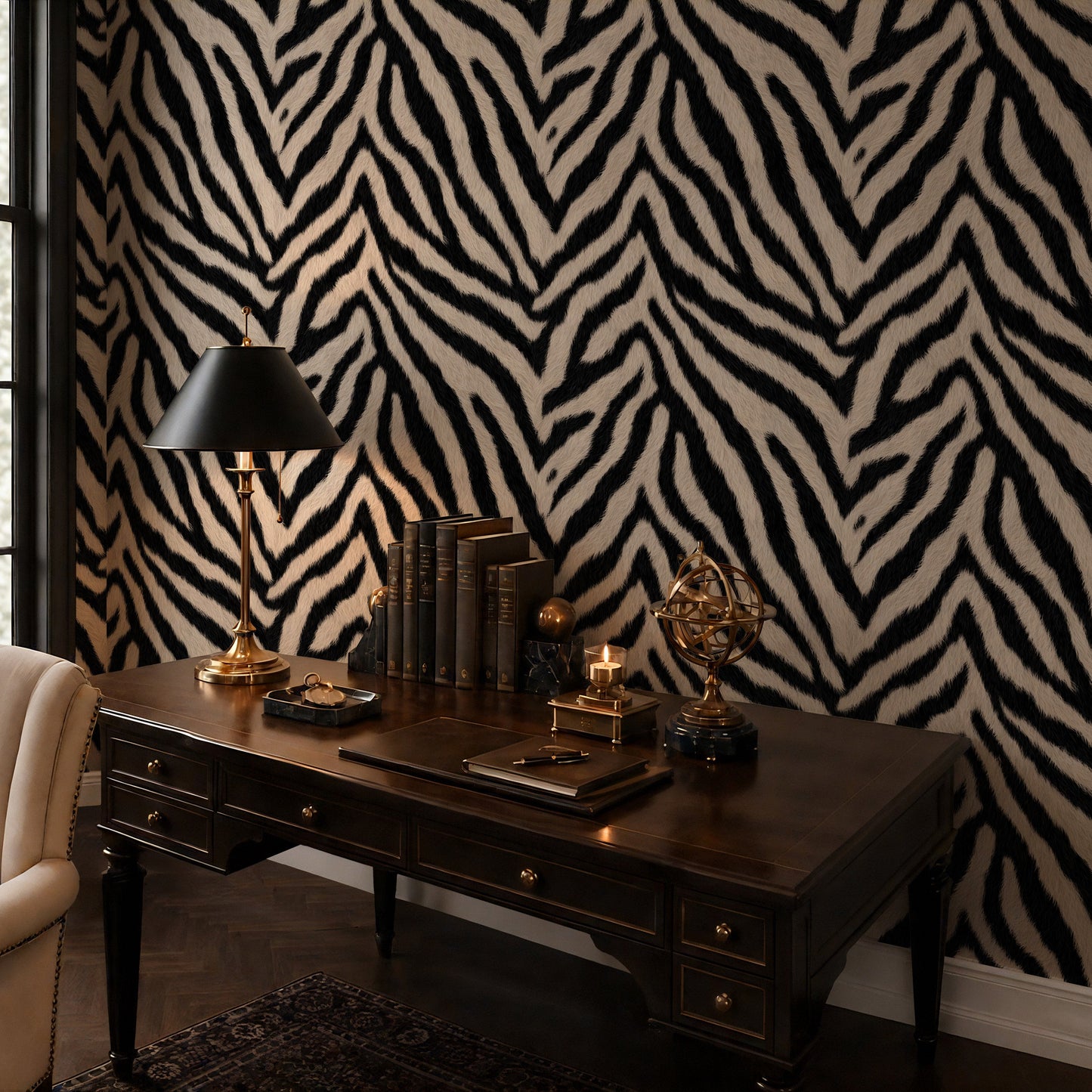 Zebra print wallpaper in a moody home office with dark wood desk and brass lamp