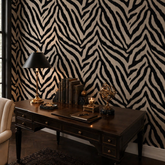 Zebra print wallpaper in a moody home office with dark wood desk and brass lamp