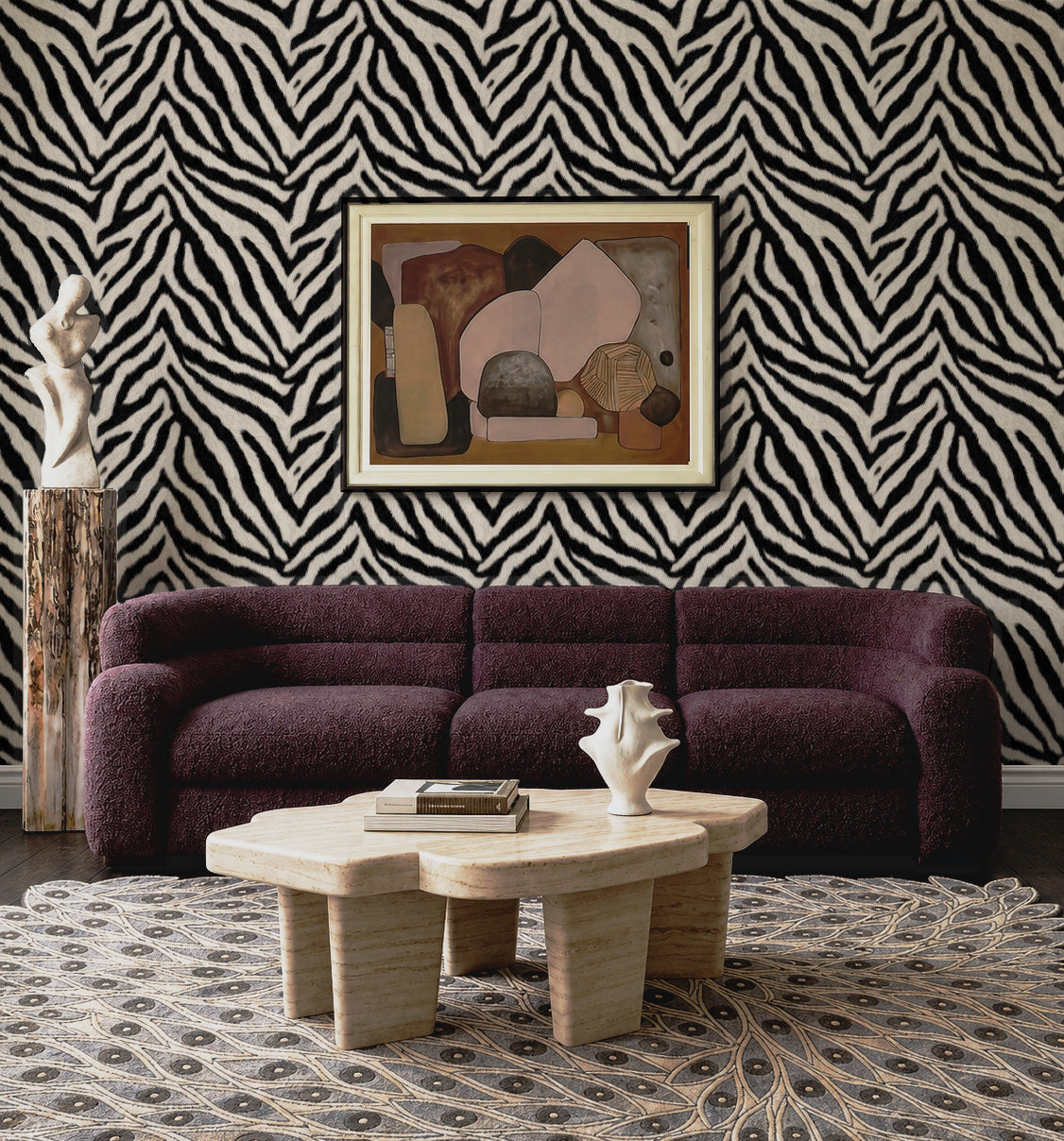 Zebra print wallpaper in a dramatic living room with plum boucle sofa and travertine coffee table