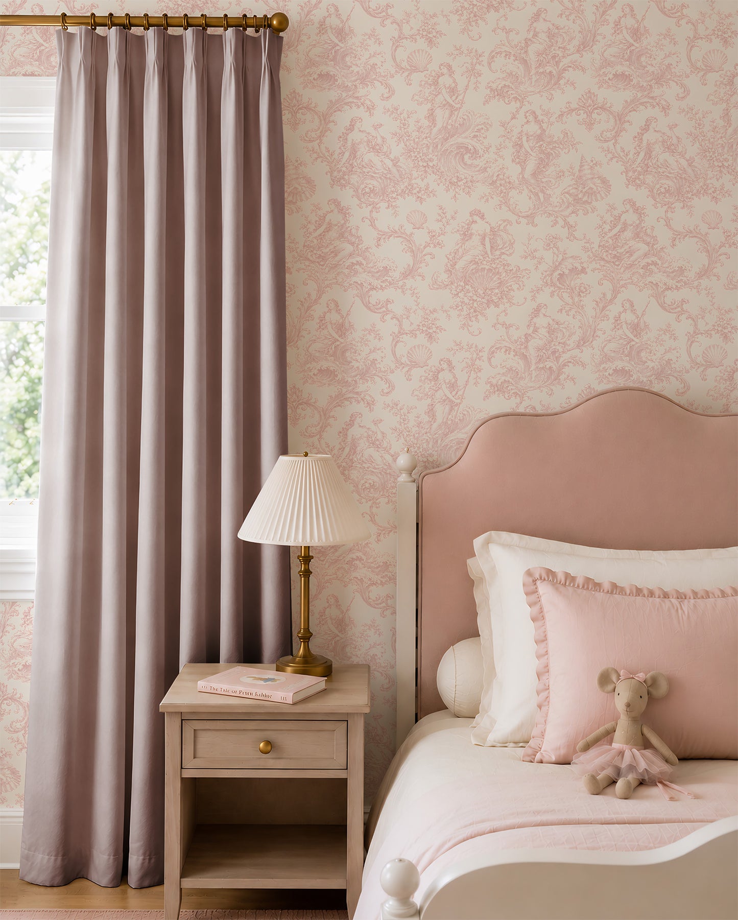 Pink Goddess Toile Wallpaper in a girl's bedroom with pink upholstered bed and gold curtain rod